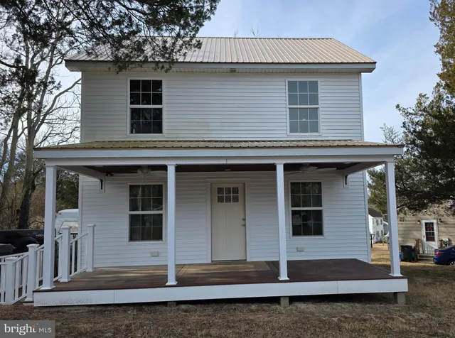 a front view of a house with stairs