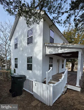 a view of a house with a yard and furniture