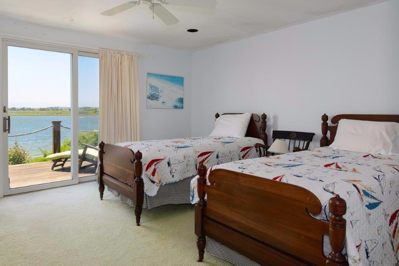 11 Riverside Way West Dennis, MA 02670 - Photo 12 of 25 a bedroom with two beds and a large window