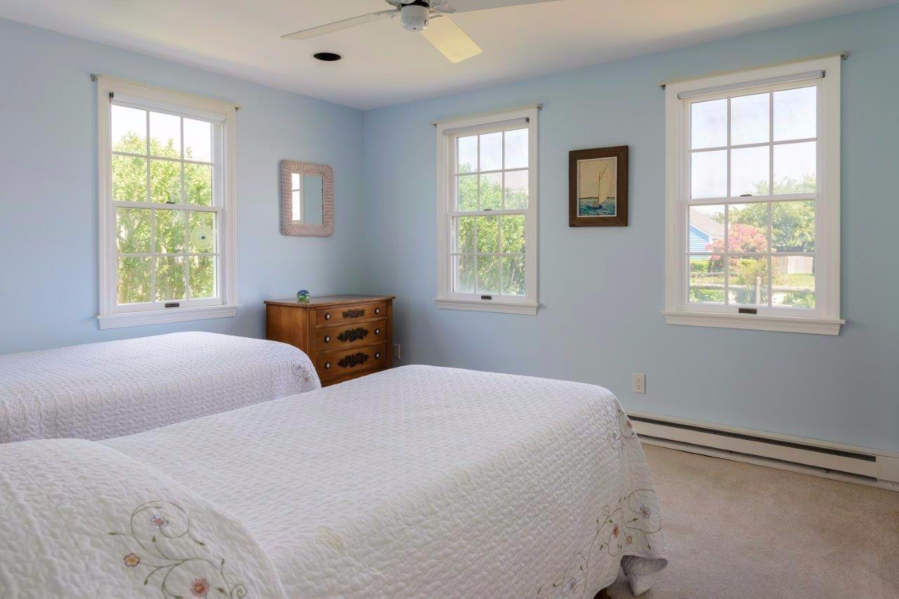 11 Riverside Way West Dennis, MA 02670 - Photo 13 of 25 a bedroom with two beds and a window
