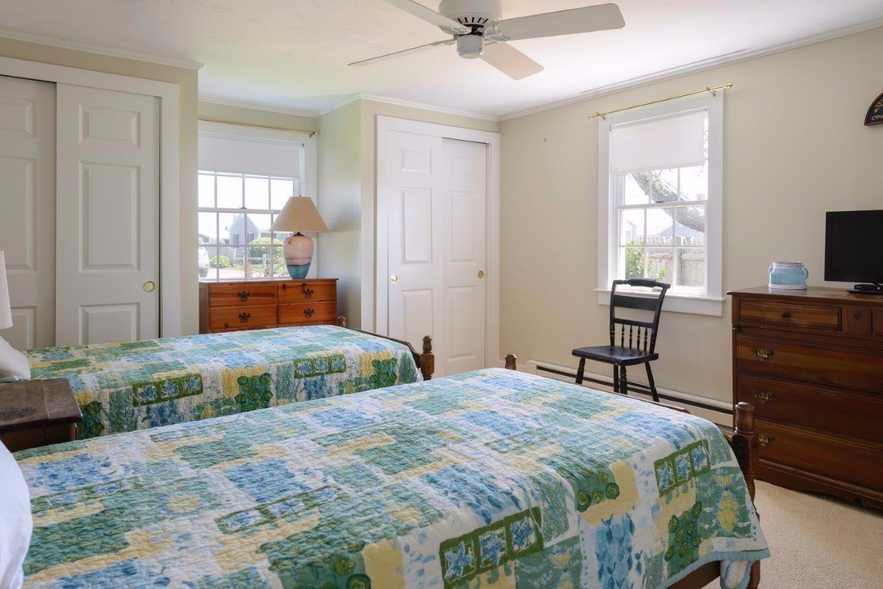 11 Riverside Way West Dennis, MA 02670 - Photo 14 of 25 a bedroom with a bed and wooden floor