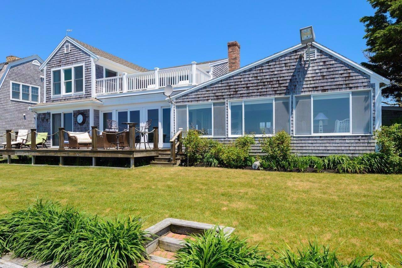 11 Riverside Way West Dennis, MA 02670 - Photo 21 of 25 a front view of a house with swimming pool having outdoor seating