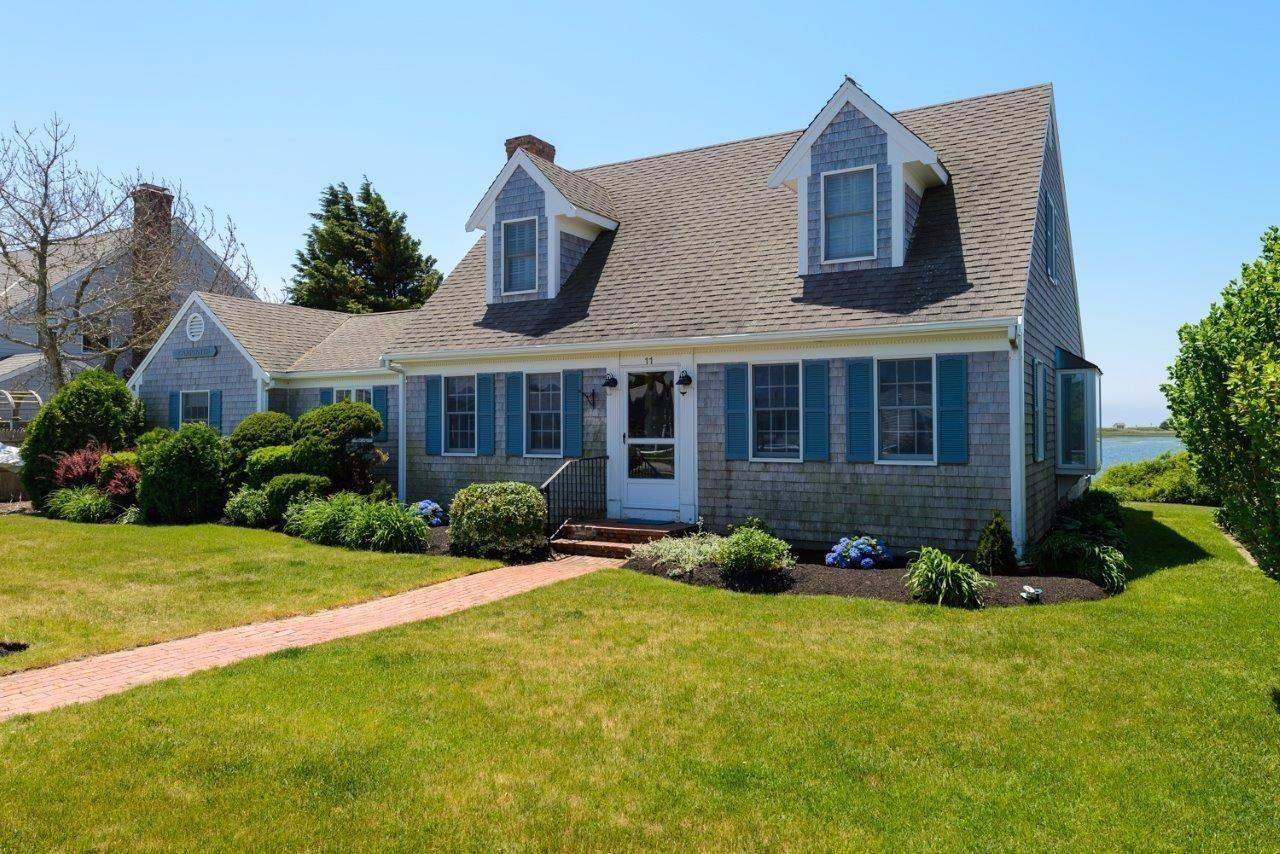 11 Riverside Way West Dennis, MA 02670 - Photo 3 of 25 a front view of a house with yard and green space