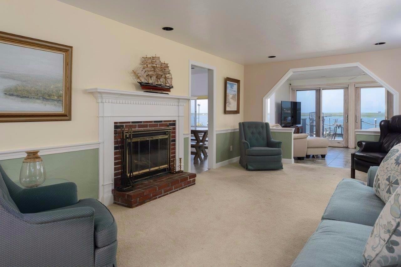 11 Riverside Way West Dennis, MA 02670 - Photo 7 of 25 a living room with furniture and a fireplace