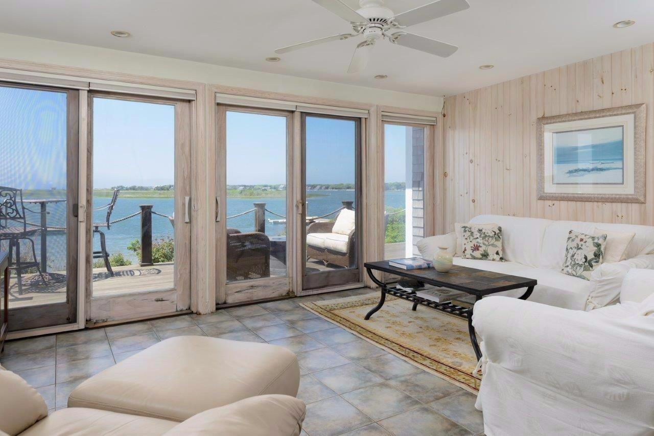 11 Riverside Way West Dennis, MA 02670 - Photo 8 of 25 a living room with furniture and large windows