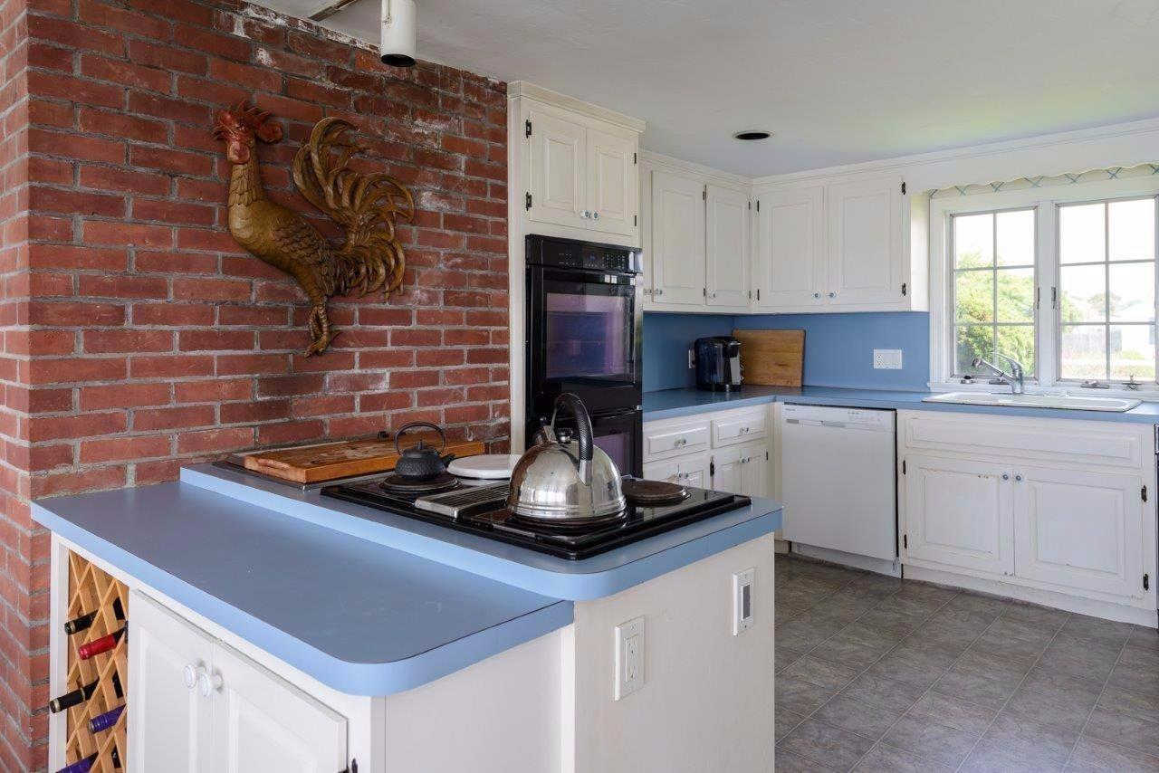 11 Riverside Way West Dennis, MA 02670 - Photo 9 of 25 a kitchen with stainless steel appliances granite countertop a sink stove and cabinets