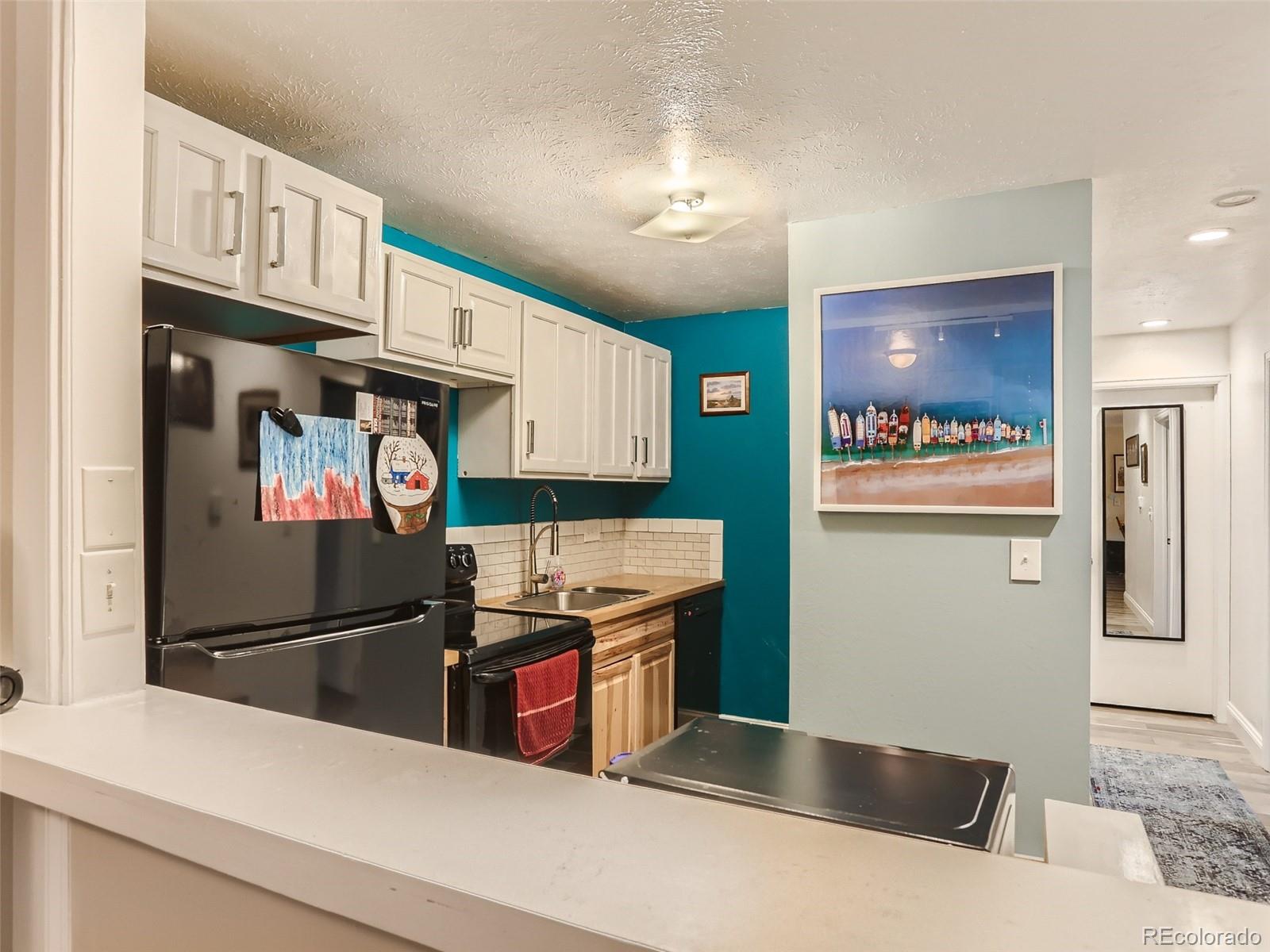 8060 Niwot Road, Unit 58 Niwot, CO 80503 - Photo 11 of 25 a kitchen with stainless steel appliances granite countertop a refrigerator and a sink