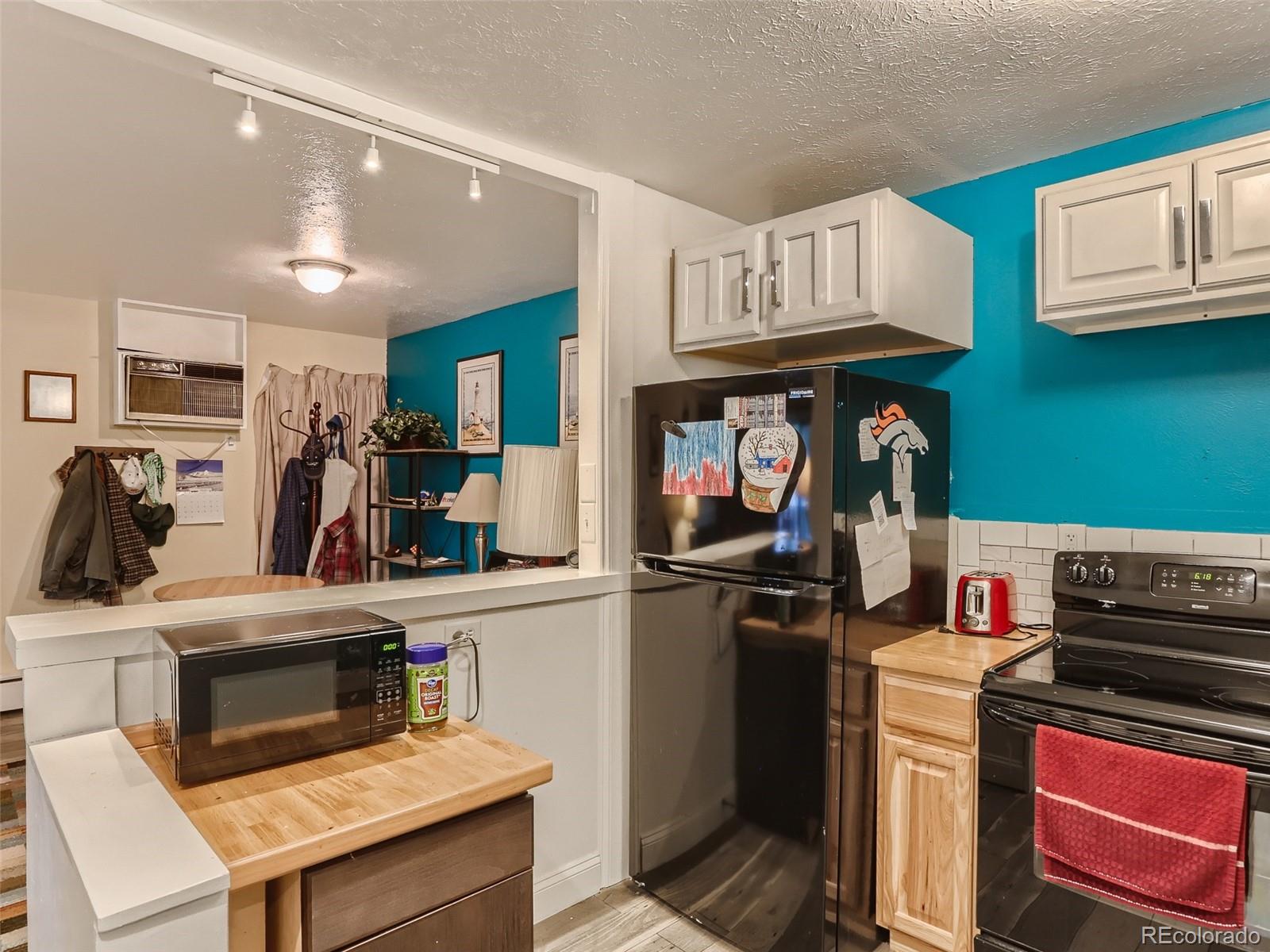 8060 Niwot Road, Unit 58 Niwot, CO 80503 - Photo 12 of 25 a kitchen with a refrigerator and a stove top oven