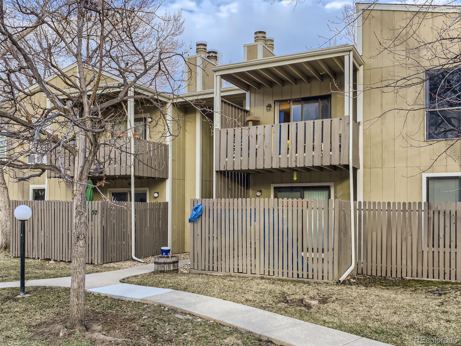 8060 Niwot Road, Unit 58 Niwot, CO 80503 - Photo 3 of 25 a front view of a house with a fence