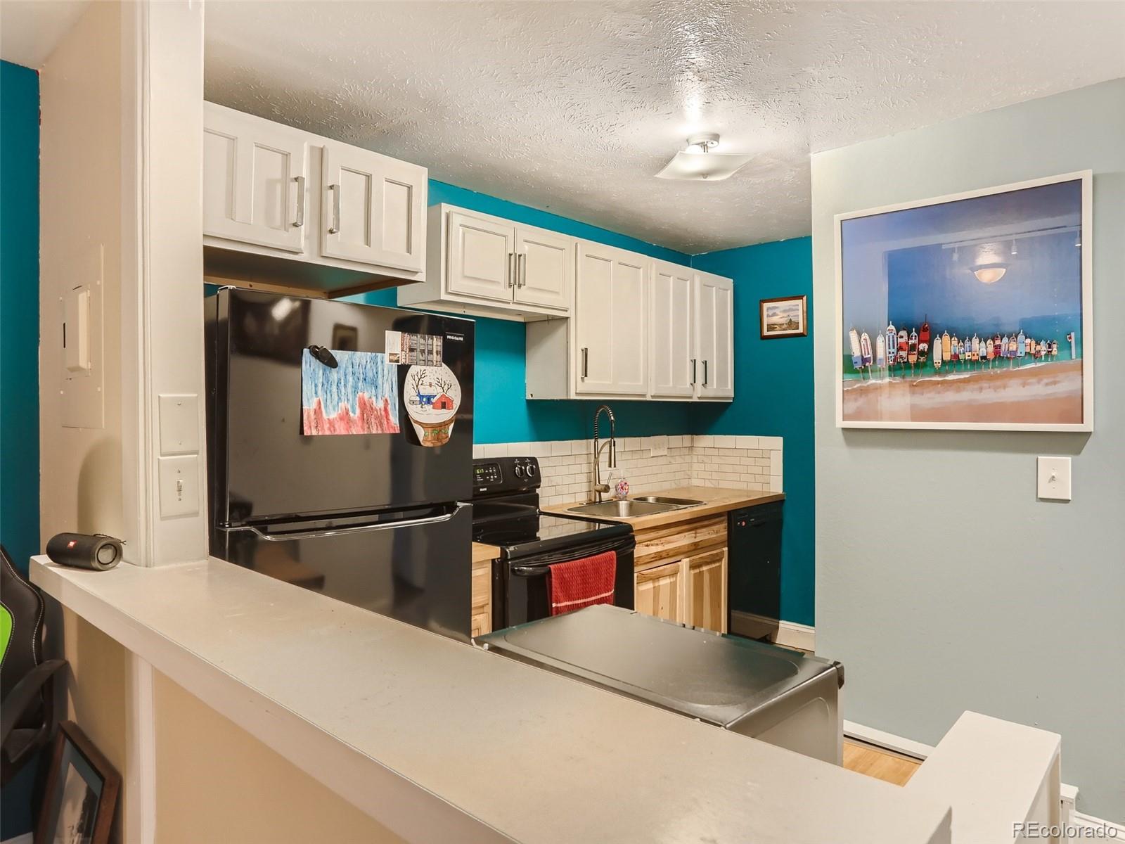 8060 Niwot Road, Unit 58 Niwot, CO 80503 - Photo 10 of 25 a kitchen with stainless steel appliances a stove refrigerator and sink