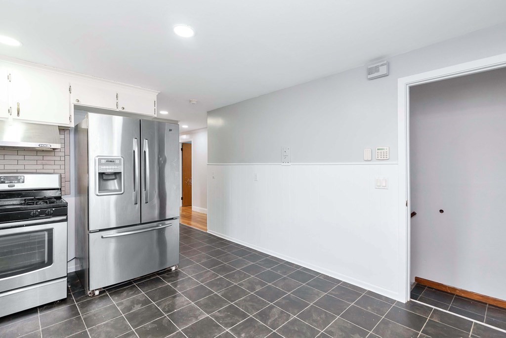 14 Scarsdale Road Springfield, MA 01129 - Photo 15 of 42 a metallic refrigerator freezer a stove sitting inside of a kitchen