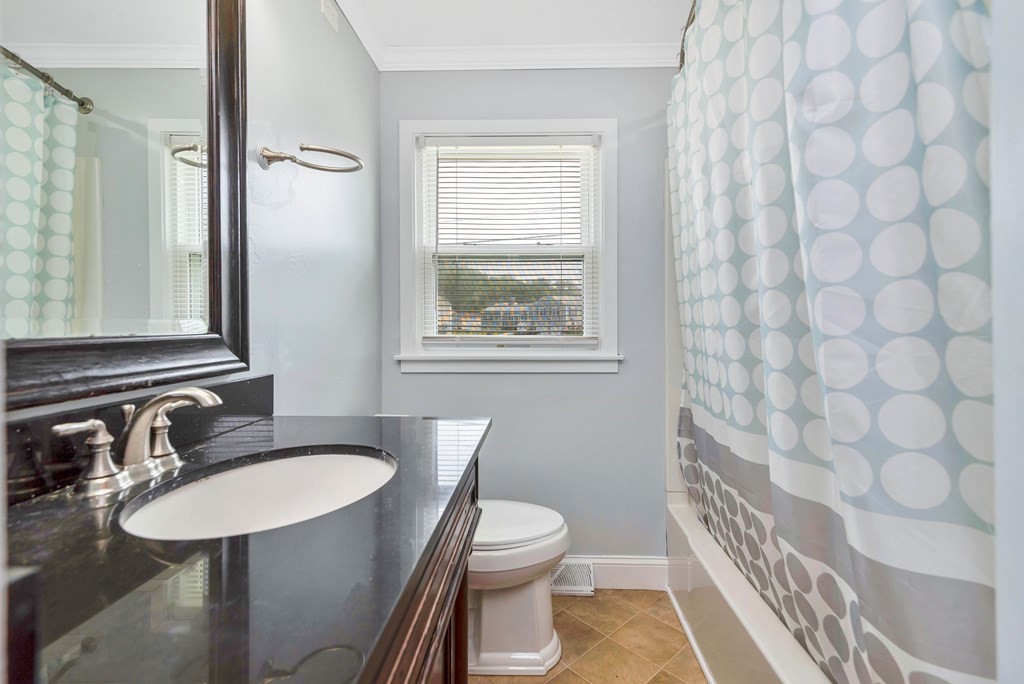 14 Scarsdale Road Springfield, MA 01129 - Photo 17 of 42 a bathroom with a sink a toilet a mirror and shower curtain