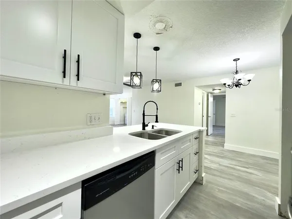 a spacious bathroom with a sink and a mirror
