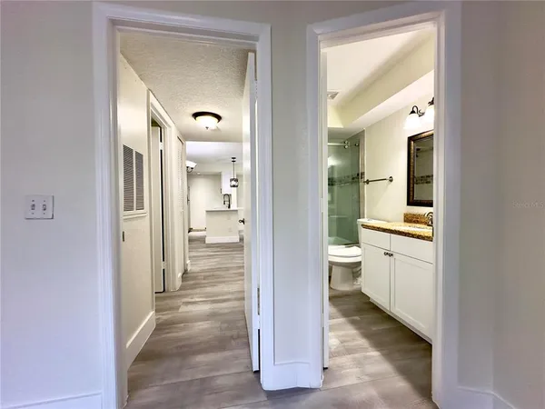 a view of a hallway with bathroom and bathroom
