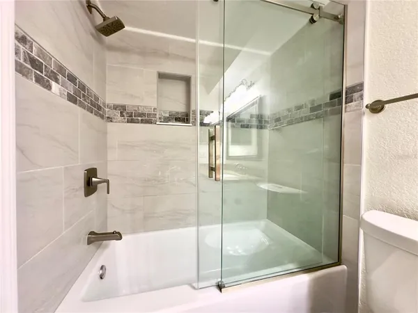a bathroom with a bathtub and a shower