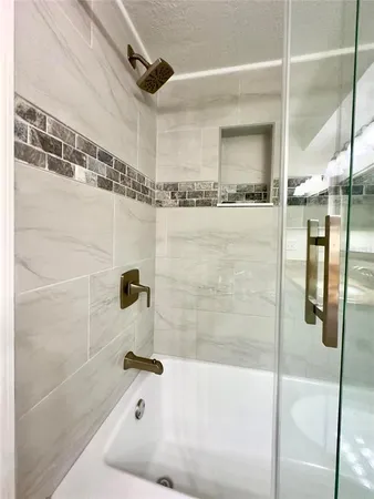 a bathroom with a bathtub and shower