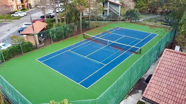 an aerial view of a house with a yard