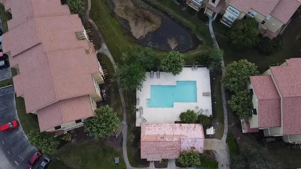 an aerial view of a house with a yard and pool