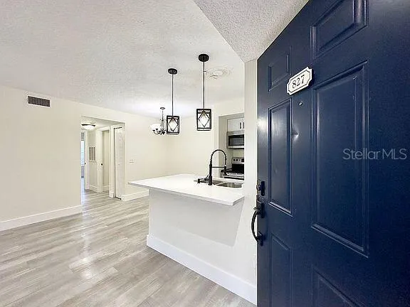 a view of a kitchen with a refrigerator a sink and dishwasher