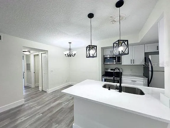 a kitchen with a refrigerator a sink and dishwasher