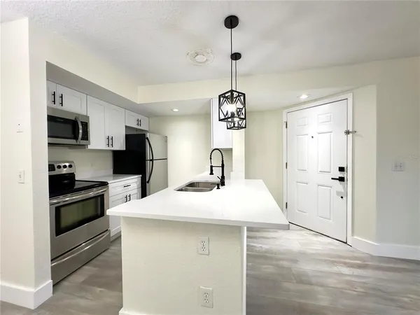 a kitchen with a refrigerator a sink dishwasher a stove and a refrigerator