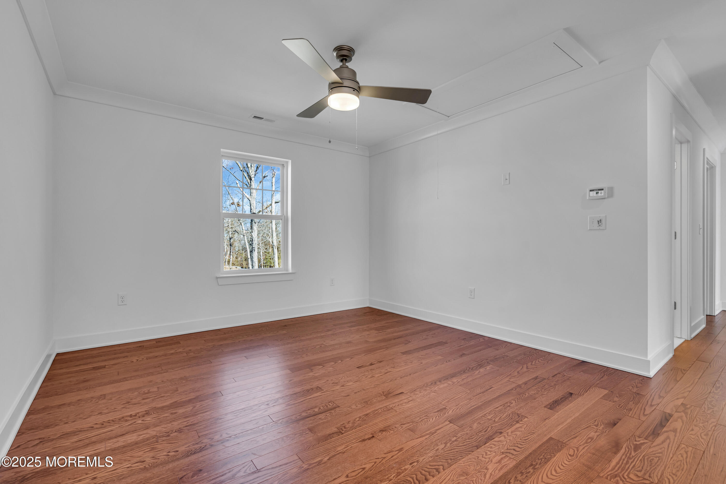 35 Pennsylvania Avenue Waretown, NJ 08758 - Photo 33 of 65 an empty room with wooden floor ceiling fan and windows