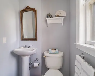 a bathroom with a toilet sink and mirror
