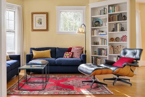 a living room with furniture and a book shelf