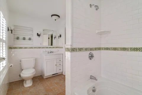 a spacious bathroom with a granite countertop sink and a mirror