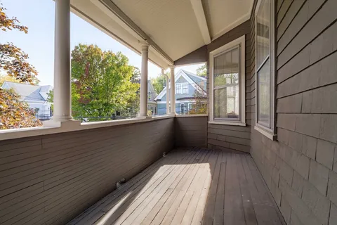 a view of a balcony with wooden floor
