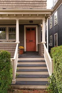 a view of a house with large windows and stairs