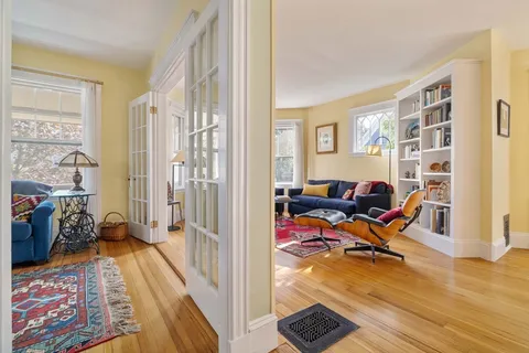 a view of a livingroom with lounge chair and a window