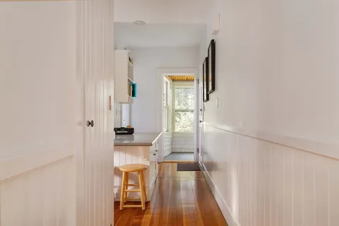 a view of a living room with furniture and wooden floor