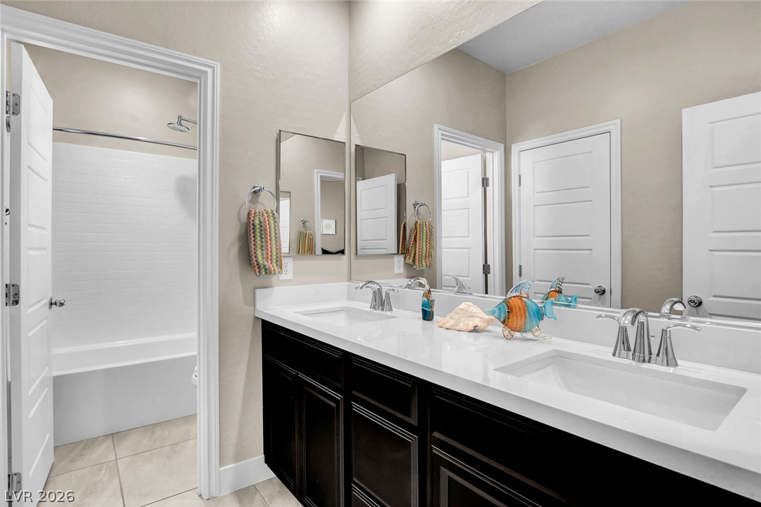 9688 Rankin Rdg Court Las Vegas, NV 89178 - Photo 33 of 53 Dual vanity with bright countertops and a shower-tub combination provide modern bathroom convenience.