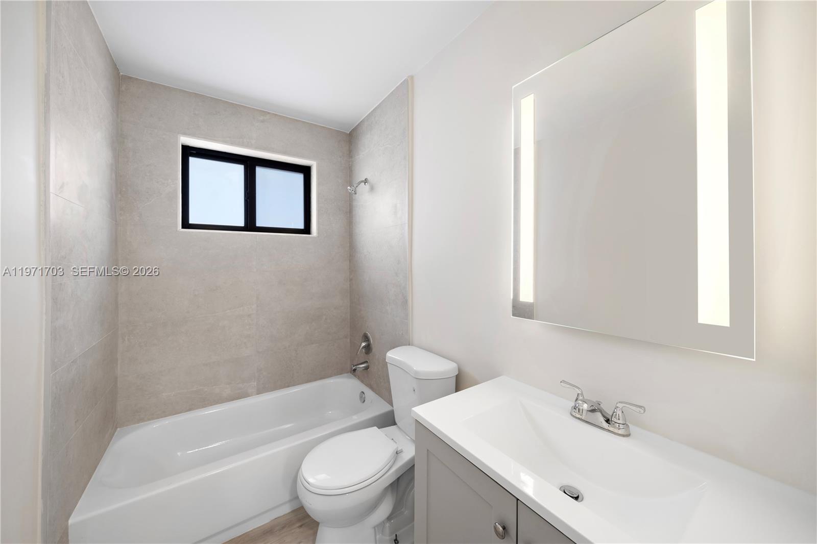 1330 West 29th Street, Unit 39 Hialeah, FL 33012 - Photo 13 of 17 a bathroom with a toilet a sink and bathtub