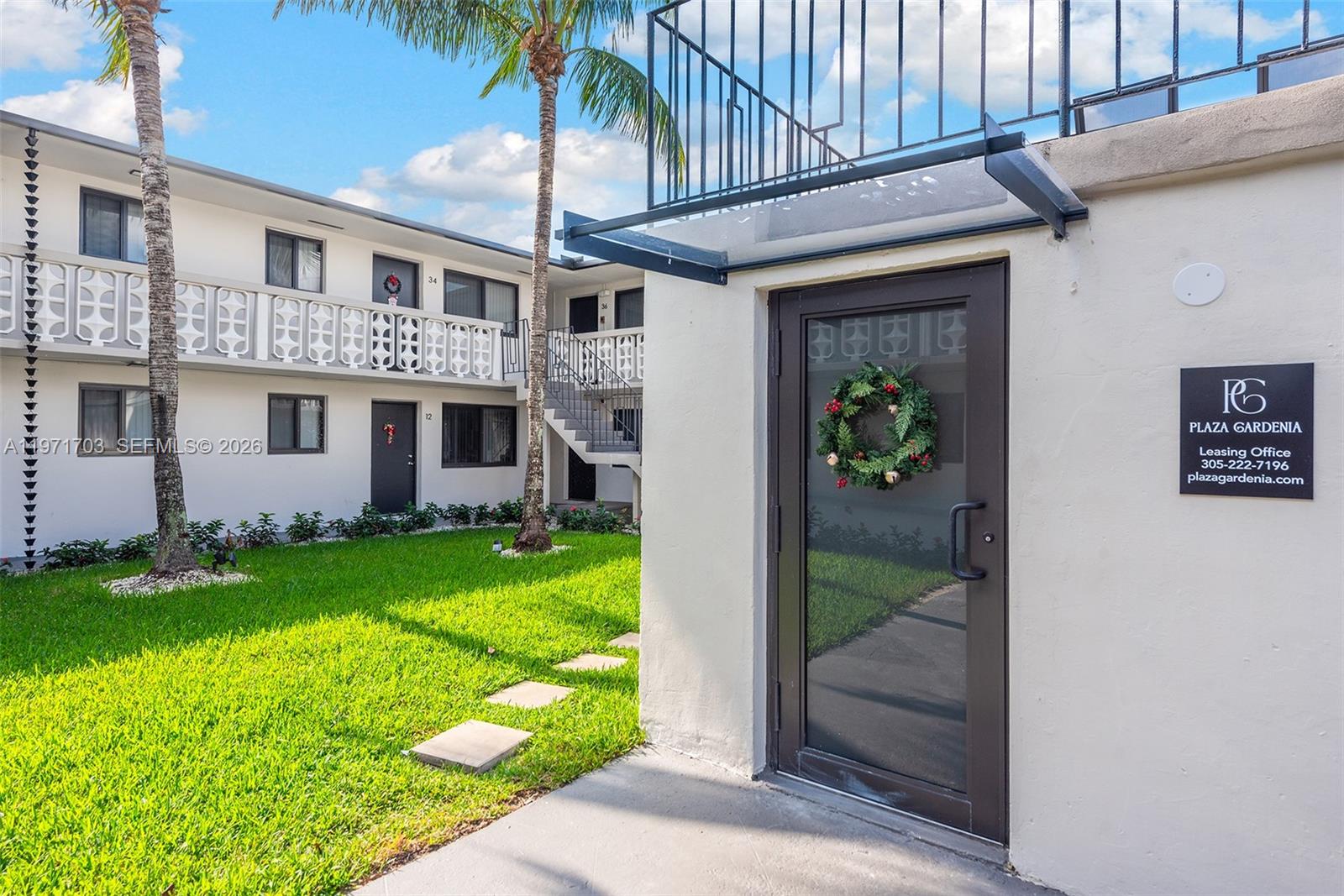 1330 West 29th Street, Unit 39 Hialeah, FL 33012 - Photo 16 of 17 a front view of a house with garden