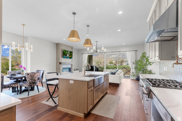 250 South Main Street, Unit 24 Alpine, UT 84004 - Photo 50 of 50 Kitchen with suspended lighting, dark wood-style floors, light stone countertops, open floor plan, and stainless steel appliances