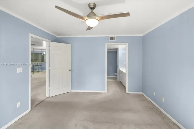 an empty room with fan and a ceiling fan