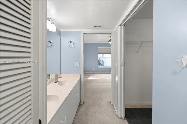 a bathroom with a tub shower and sink