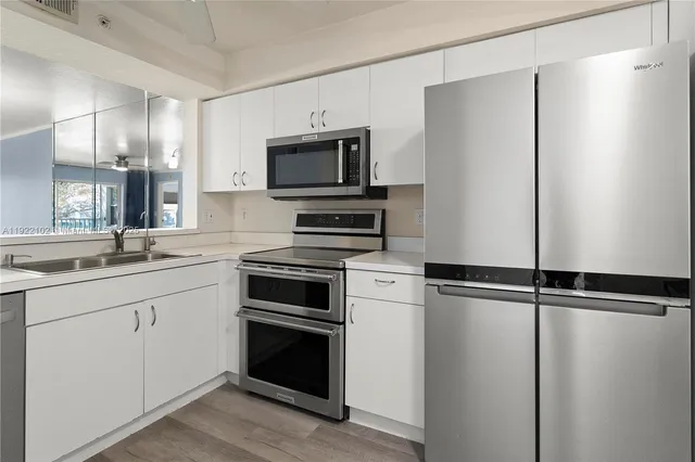 a kitchen with a refrigerator and a sink