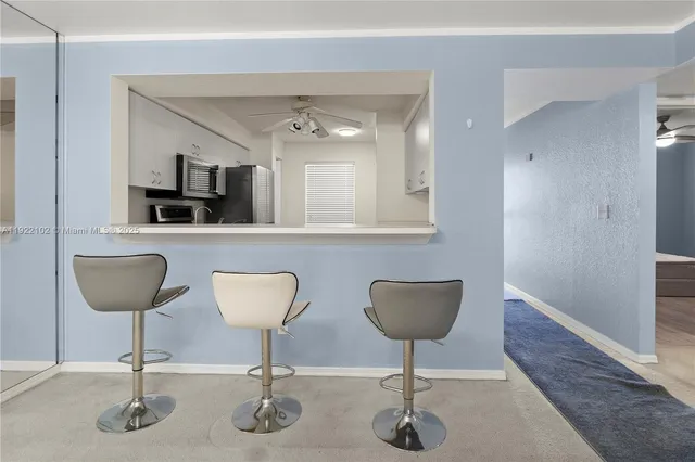 a bathroom with a potted plant and a table