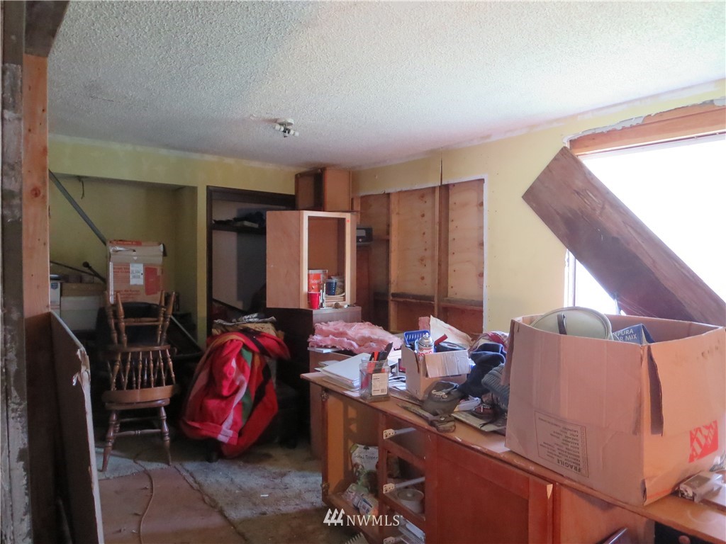 250 Logan Hill Road Chehalis, WA 98532 - Photo 11 of 25 a room with furniture a flat screen tv and a bed