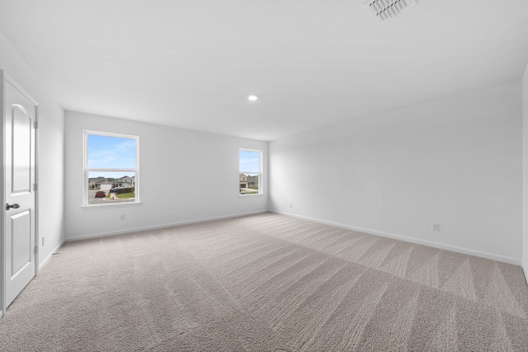 345 Silent Meadow Run Maxwell, TX 78656 - Photo 4 of 11 Empty room with light carpet, plenty of natural light, and recessed lighting