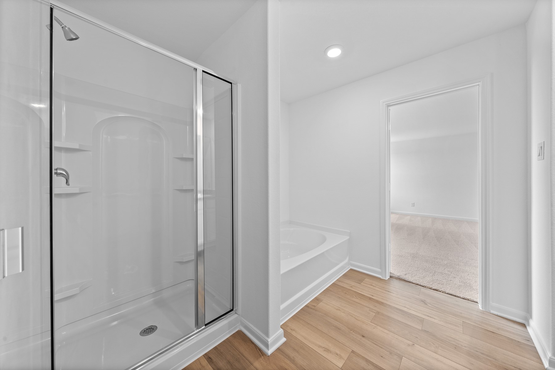 345 Silent Meadow Run Maxwell, TX 78656 - Photo 7 of 11 Full bath with a garden tub, light wood-style flooring, a shower stall, and recessed lighting
