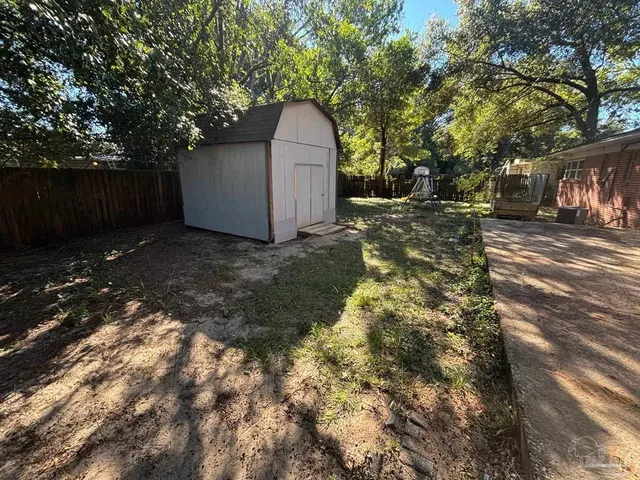 a view of a backyard with large trees