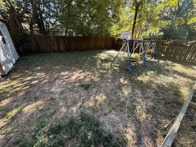a backyard of a house with a tree