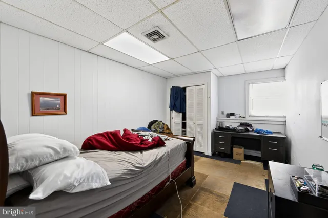 a view of a bedroom with furniture and a bed