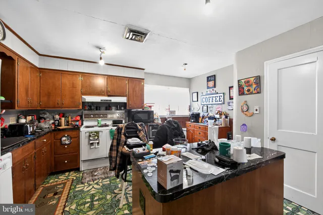 a kitchen with a sink stove and refrigerator