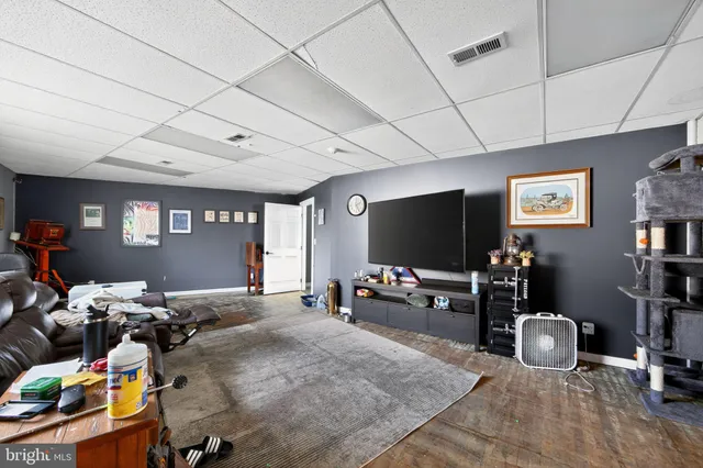 a room with furniture a flat screen tv and a large window