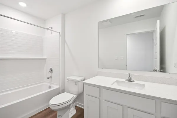 a bathroom with a sink toilet vanity and shower